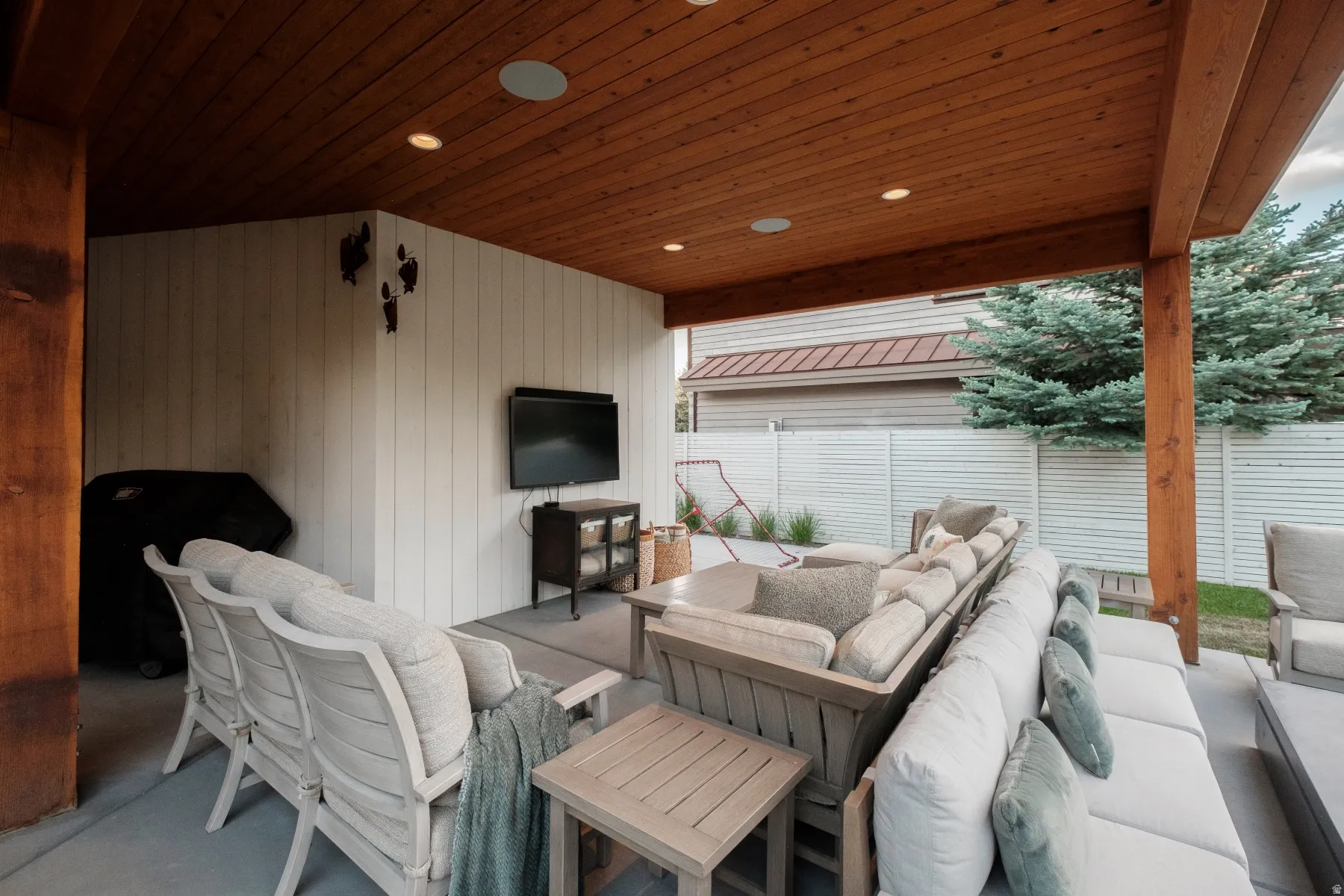 Covered patio featuring a wood-finish ceiling with recessed lighting and built-in speakers