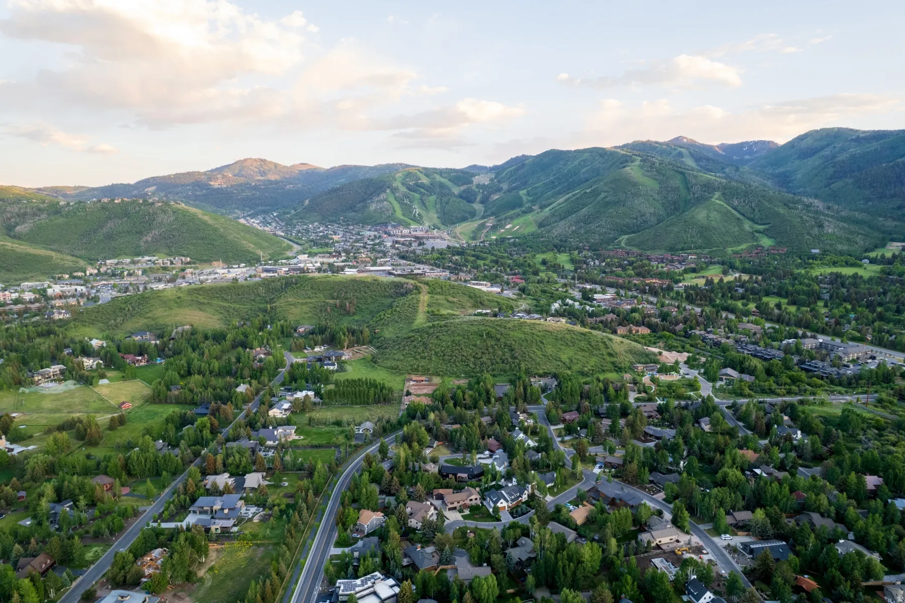 Expansive aerial perspective showcasing a mountainous landscape with a residential area