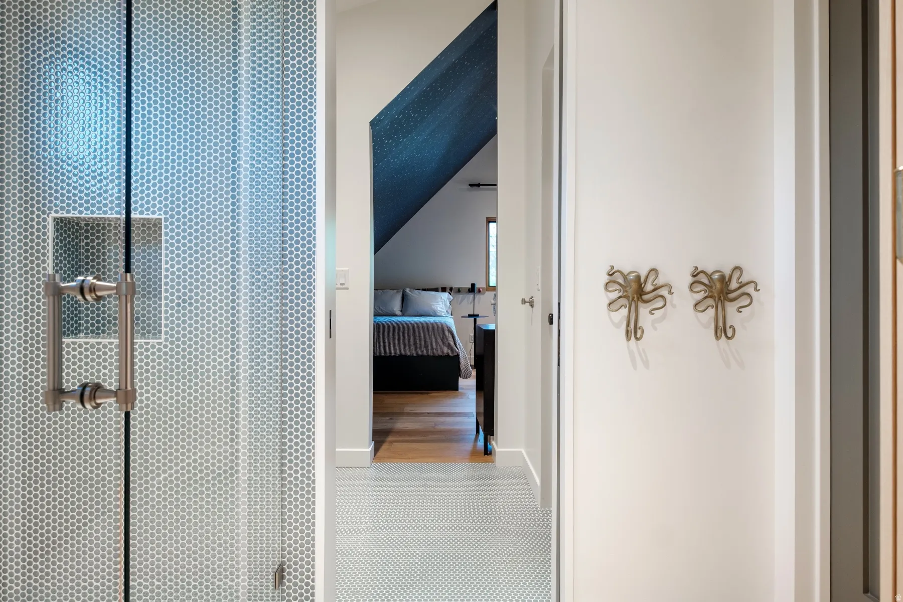 Walk-in shower featuring clear glass enclosure with brushed nickel hardware and hexagonal tile