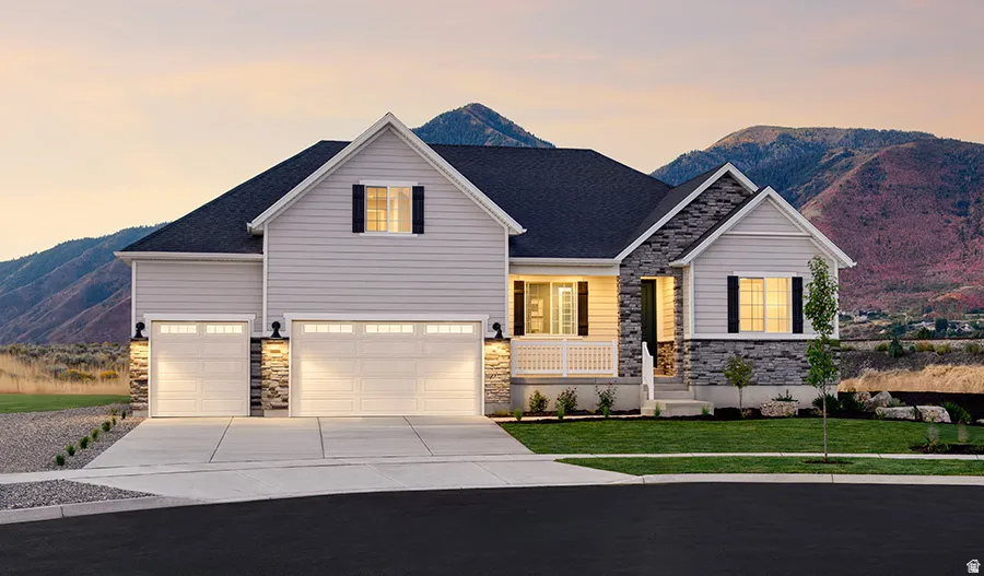 Contemporary residence featuring light-toned siding, dark roof, and stone facade accents