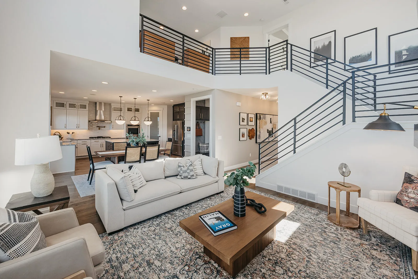Open concept living space with high ceilings and wood-finish flooring