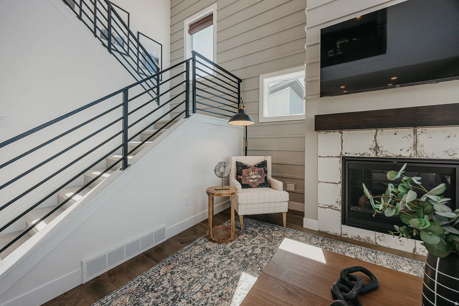 Modern staircase featuring black horizontal metal railings