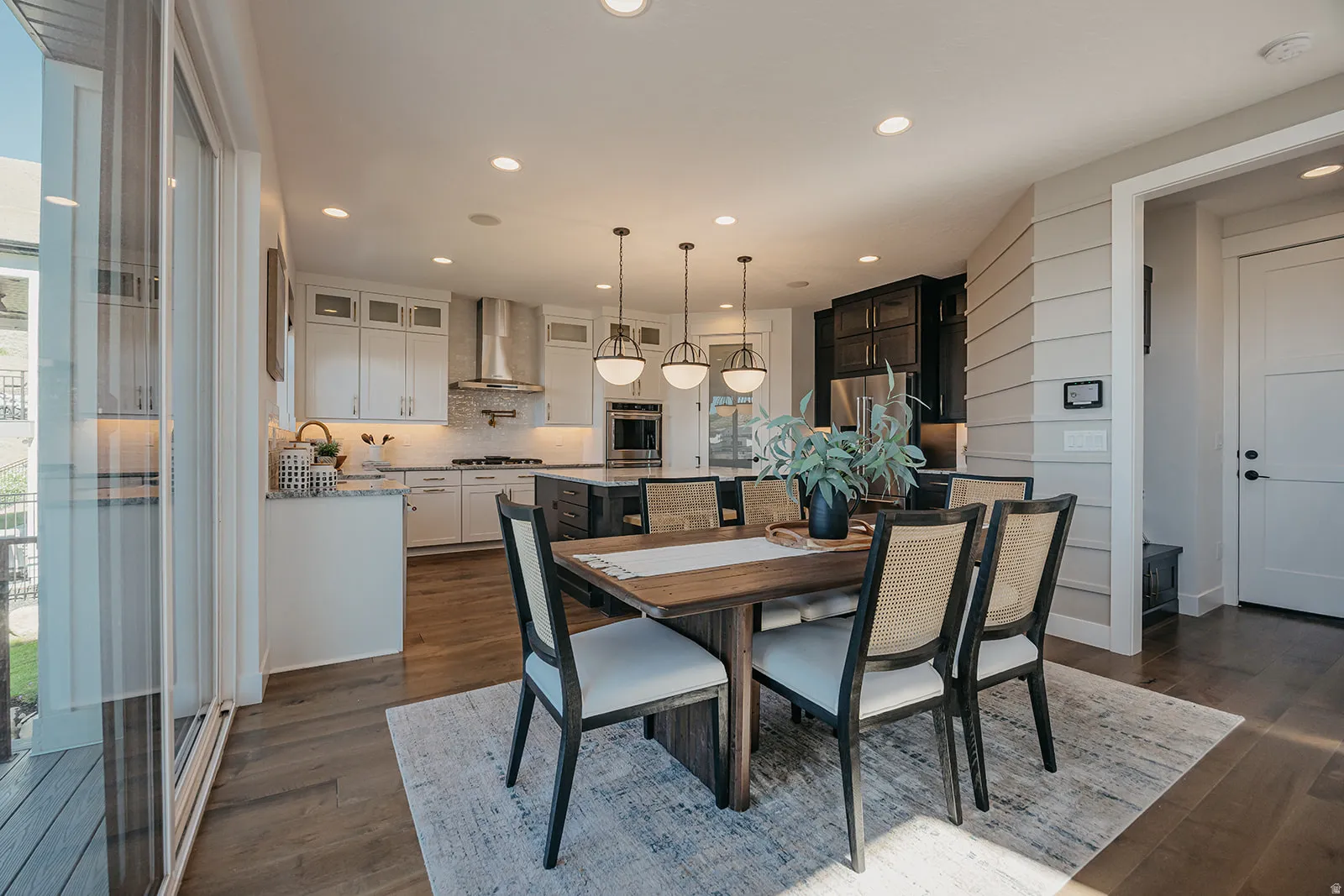 Dining area featuring wood-finish flooring and a contemporary pendant light fixture