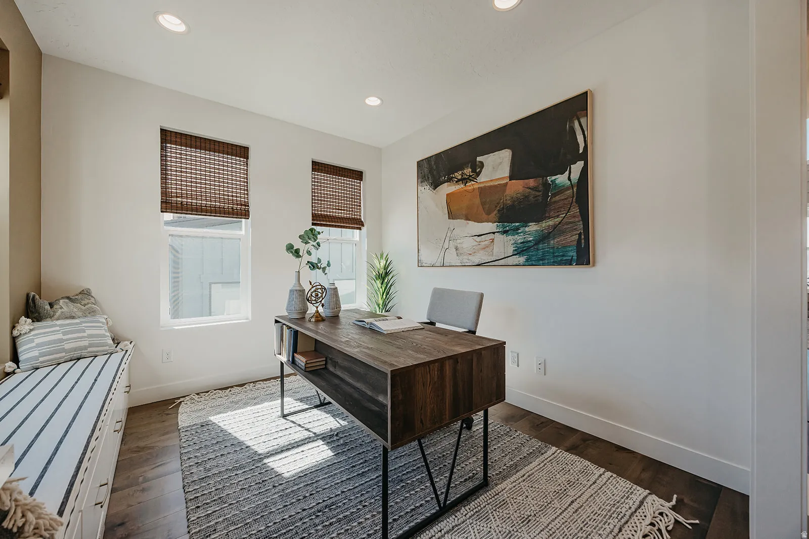 Dedicated room featuring two windows with woven blinds, recessed lighting, wood-finish flooring, and a built-in window seat with storage drawers