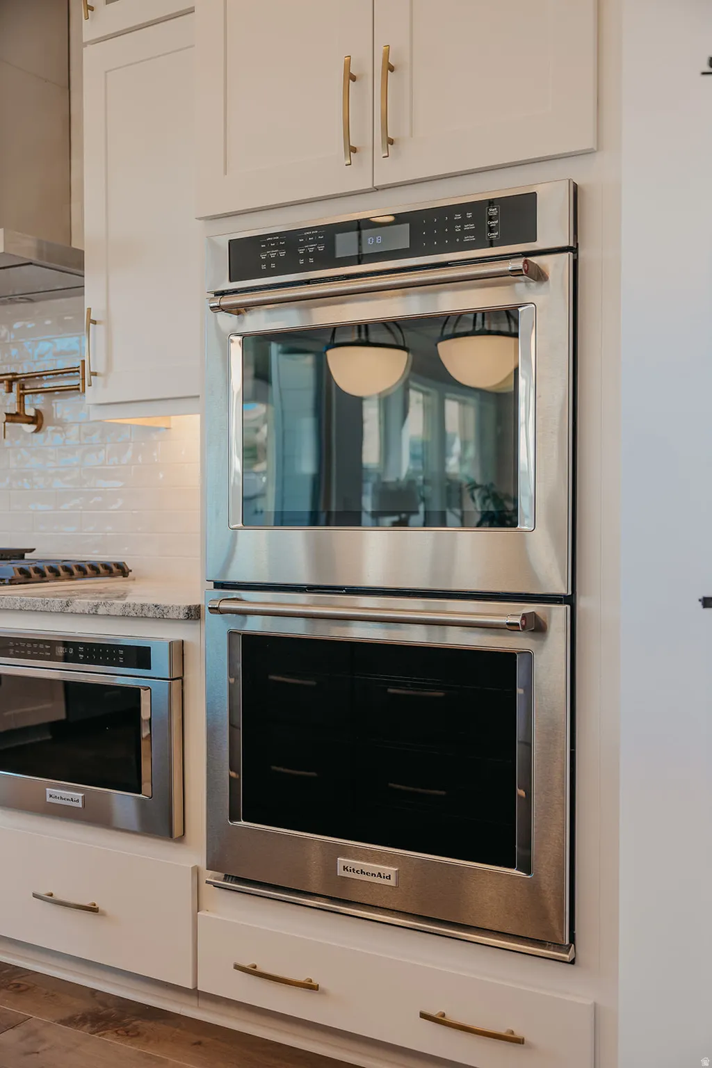Built-in stainless steel double oven with integrated controls, complemented by a coordinating stainless steel microwave