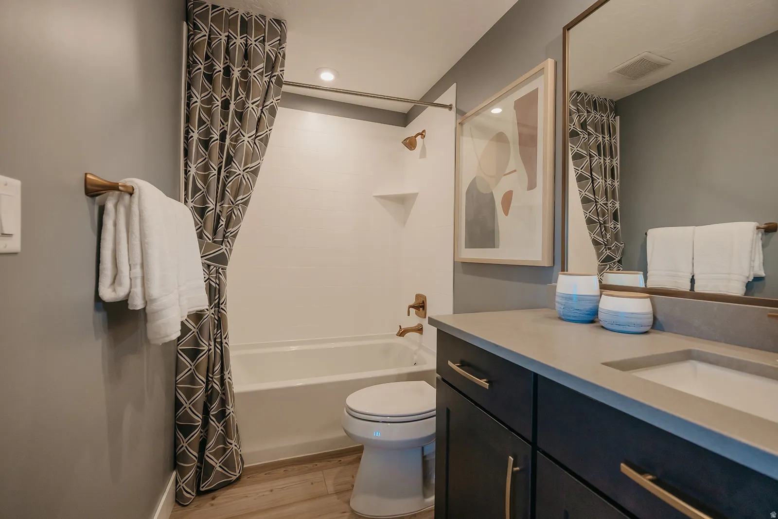 Bathroom featuring a dark wood-finish vanity with a light countertop and integrated sink