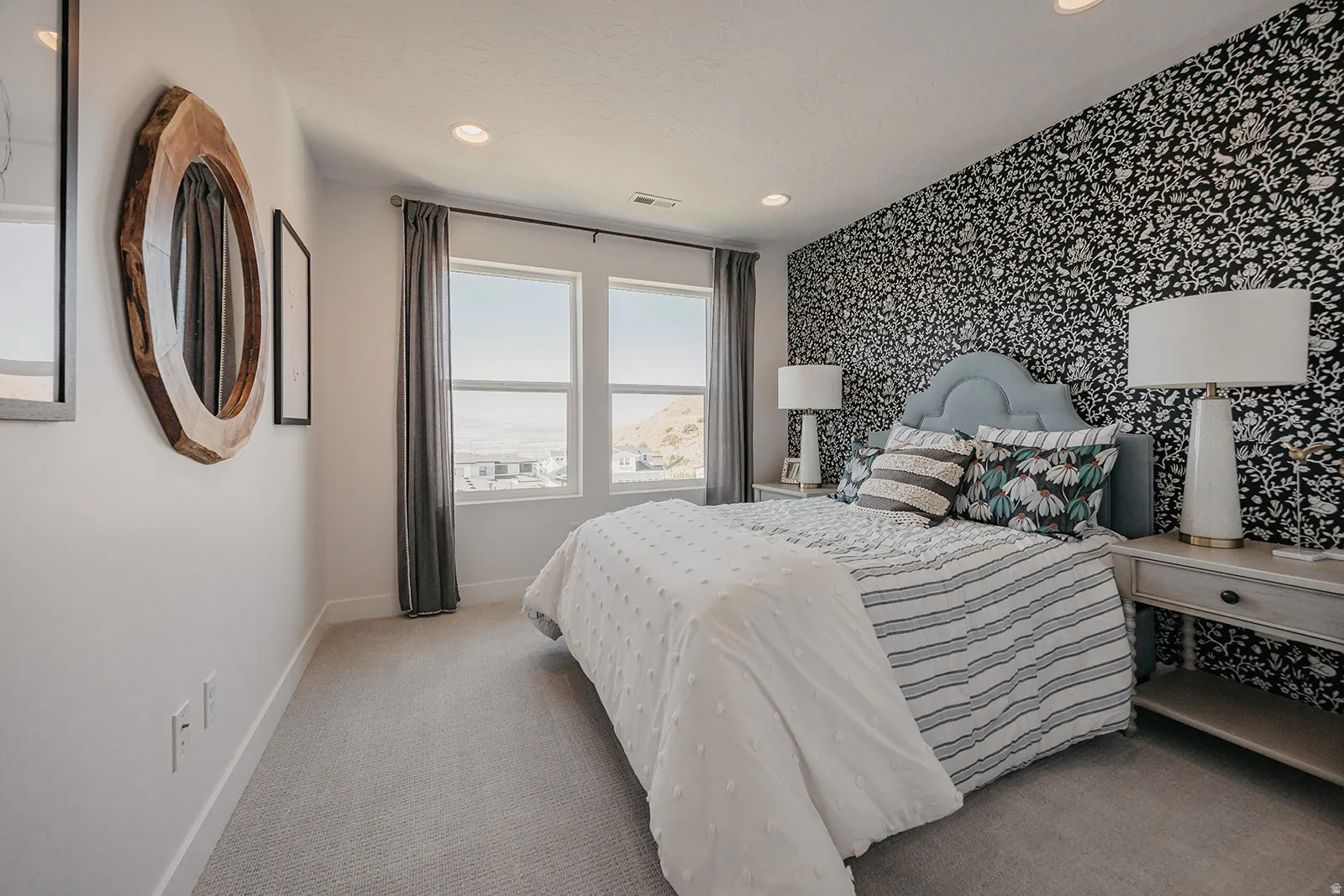 Bedroom featuring a patterned accent wall, recessed lighting, and carpet flooring