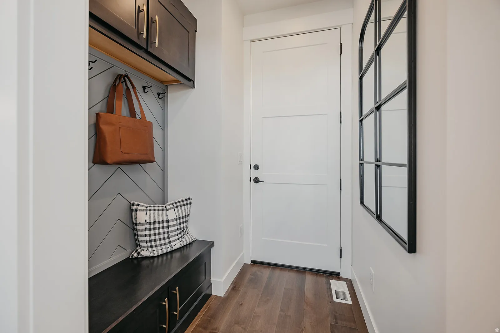 Entryway featuring wood-finish flooring and a white paneled door