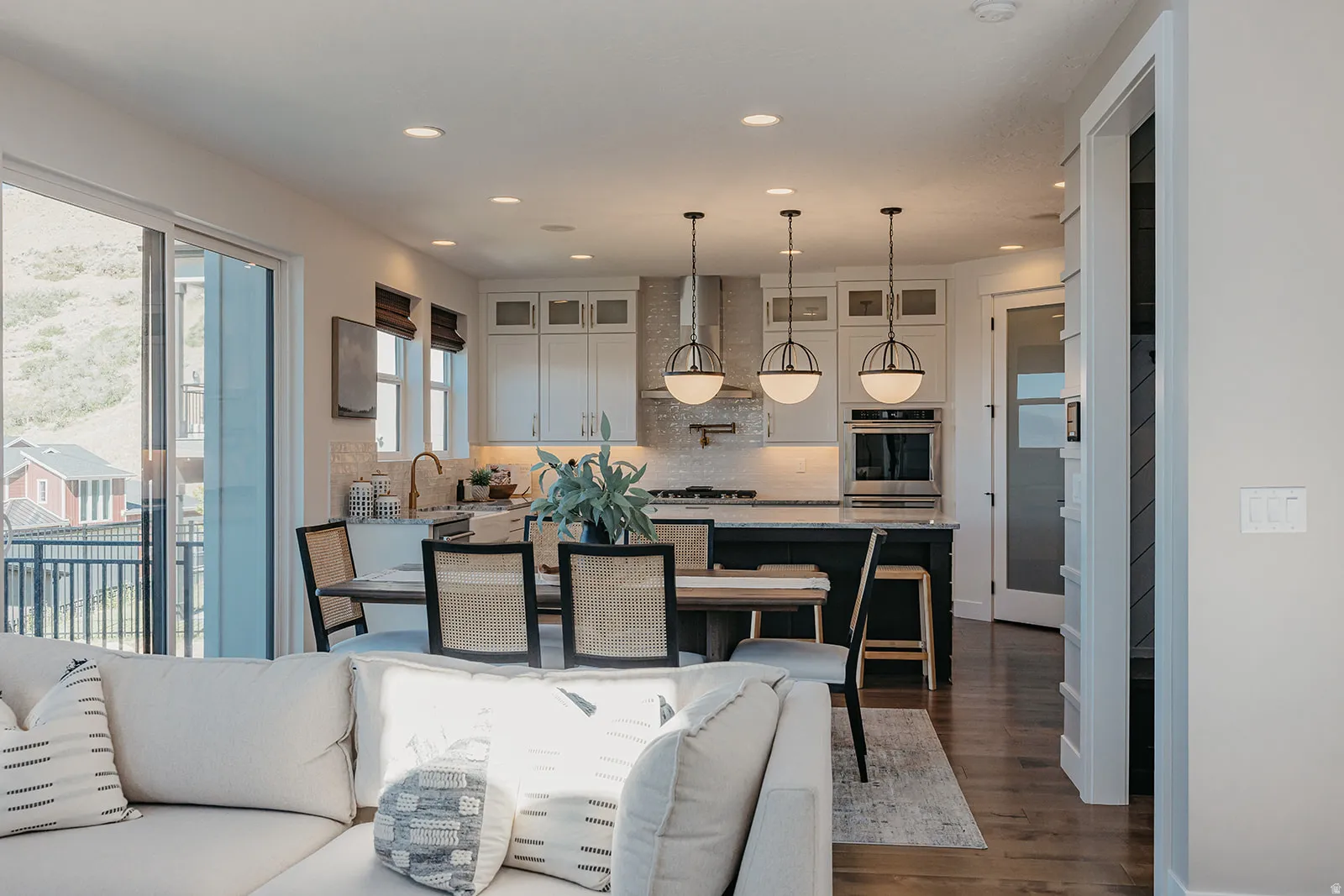 Open-concept living space featuring wood-finish flooring, recessed lighting, and a modern kitchen