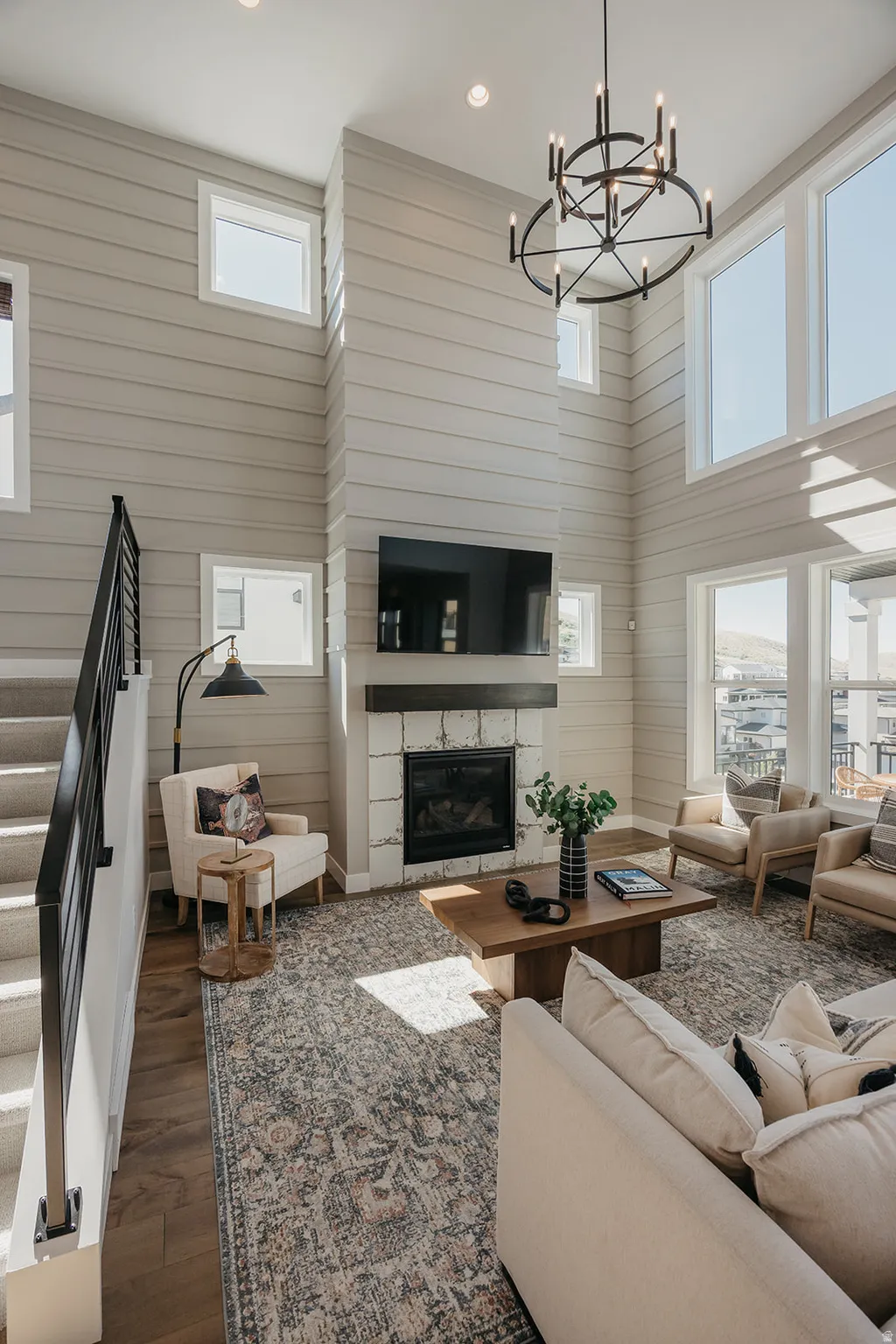 Living area featuring a floor-to-ceiling fireplace with stone surround and dark wood mantel