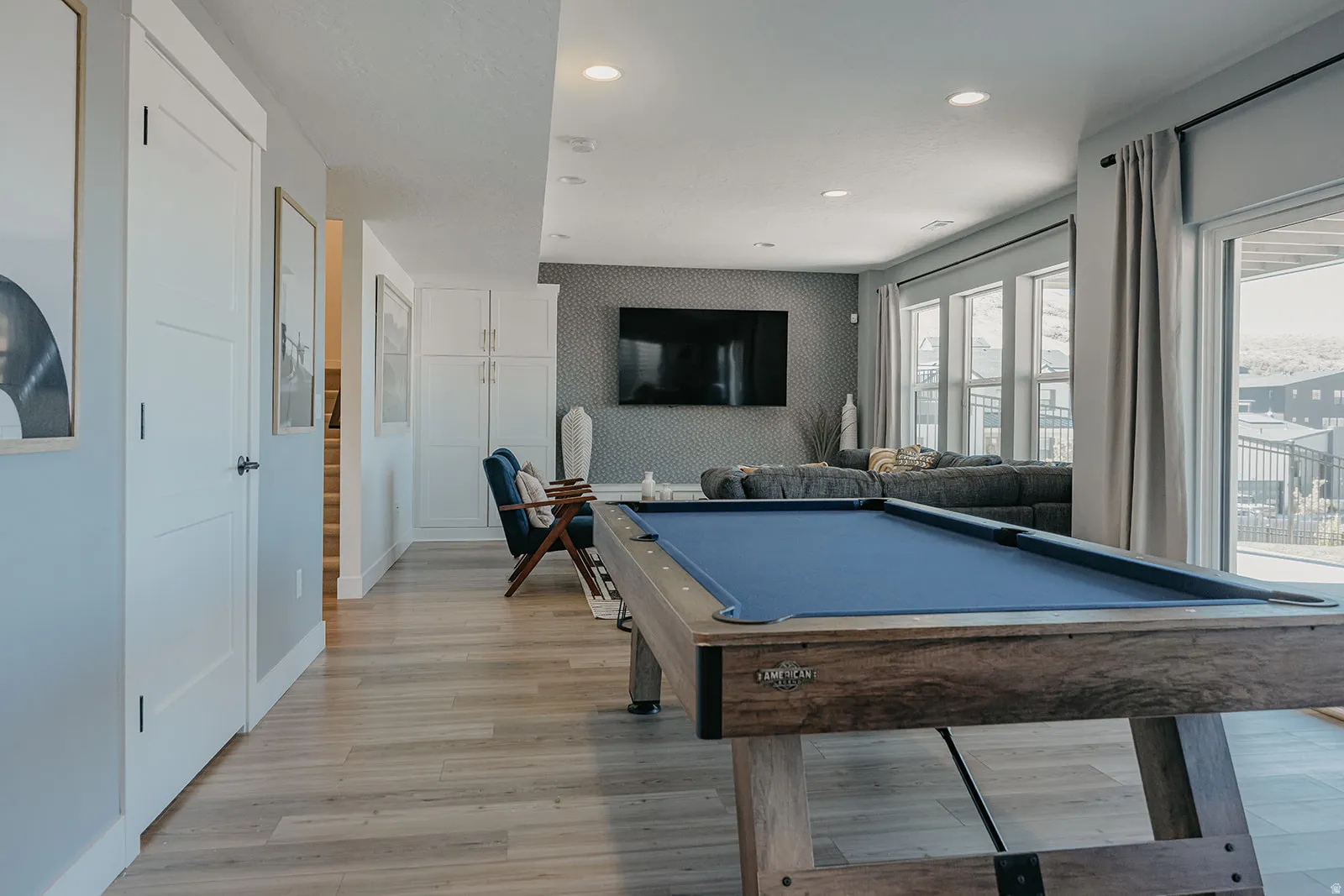 Recreational area featuring a built-in pool table, wood-finish flooring, recessed lighting, and white built-in cabinetry
