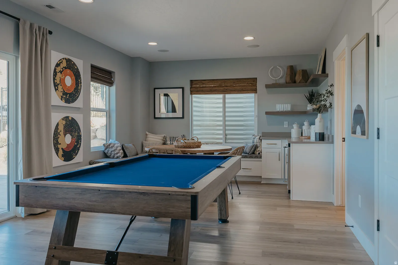 Recreation room featuring a pool table with blue felt, light wood-finish flooring, and recessed ceiling lighting