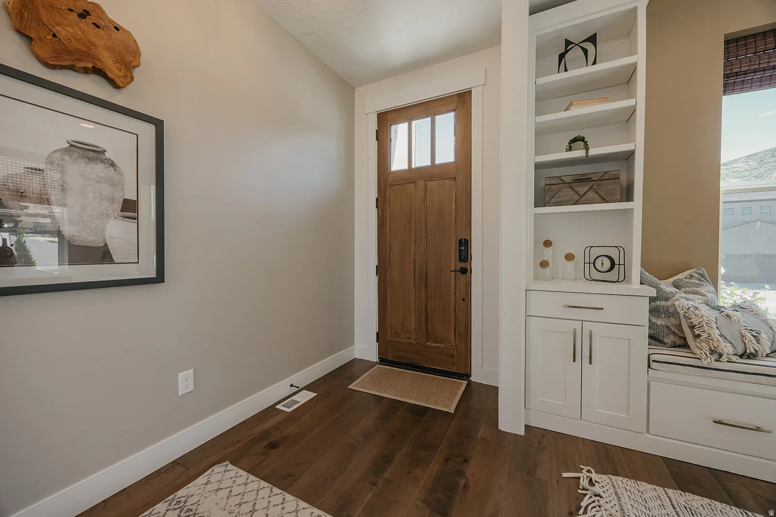 Entryway featuring a solid wood door with glass inserts, wood-finish flooring, and white trim