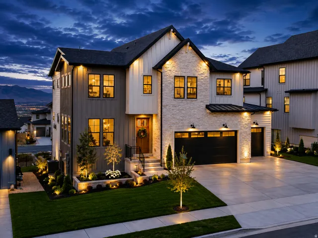 Contemporary architecture featuring stone and board-and-batten siding, black-framed windows, and a black garage door