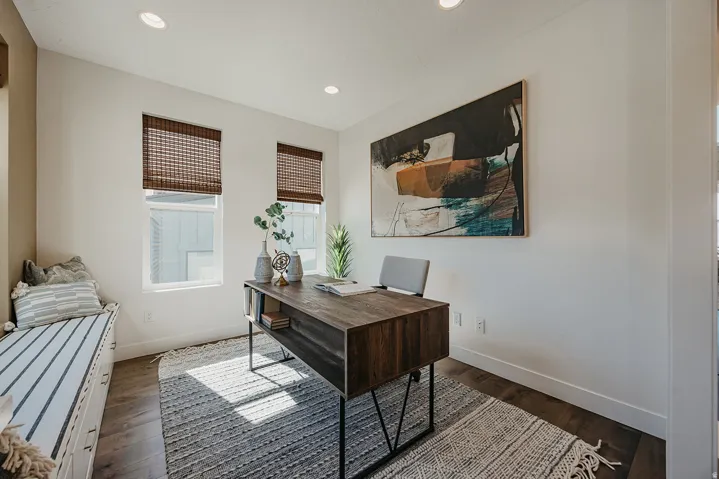 Dedicated room featuring two windows with woven blinds, recessed lighting, wood-finish flooring, and a built-in window seat with storage drawers