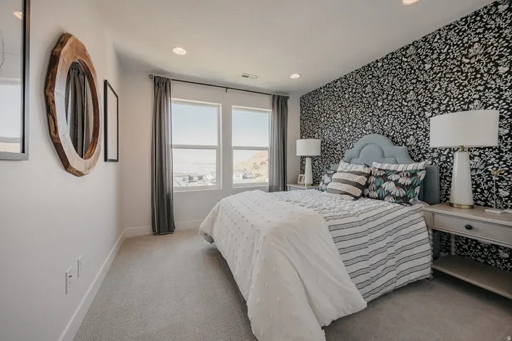 Bedroom featuring a patterned accent wall, recessed lighting, and carpet flooring