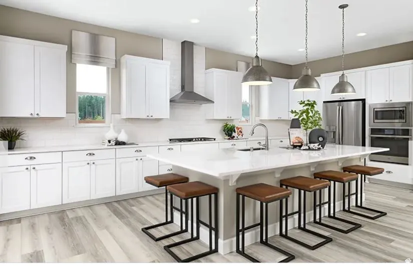 Kitchen featuring an oversized island with seating, white shaker cabinetry, stainless steel appliances, a tile backsplash, and wood-finish flooring