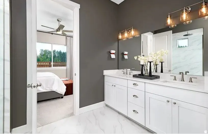 Dual vanity featuring white cabinetry, light-toned countertops, and brushed nickel hardware