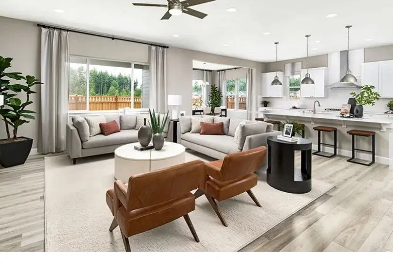 Open-concept living area featuring light wood-finish flooring, recessed lighting, a modern ceiling fan, and large windows