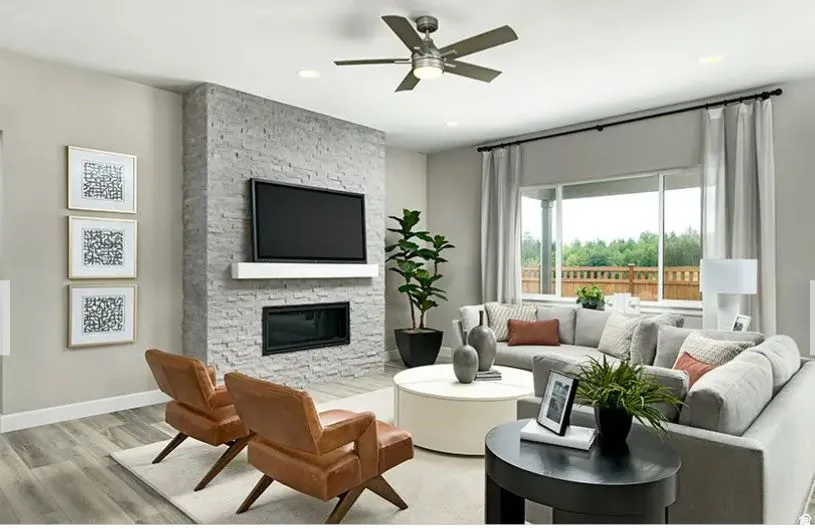 Living space featuring a stacked stone fireplace with a built-in linear electric firebox and white mantel