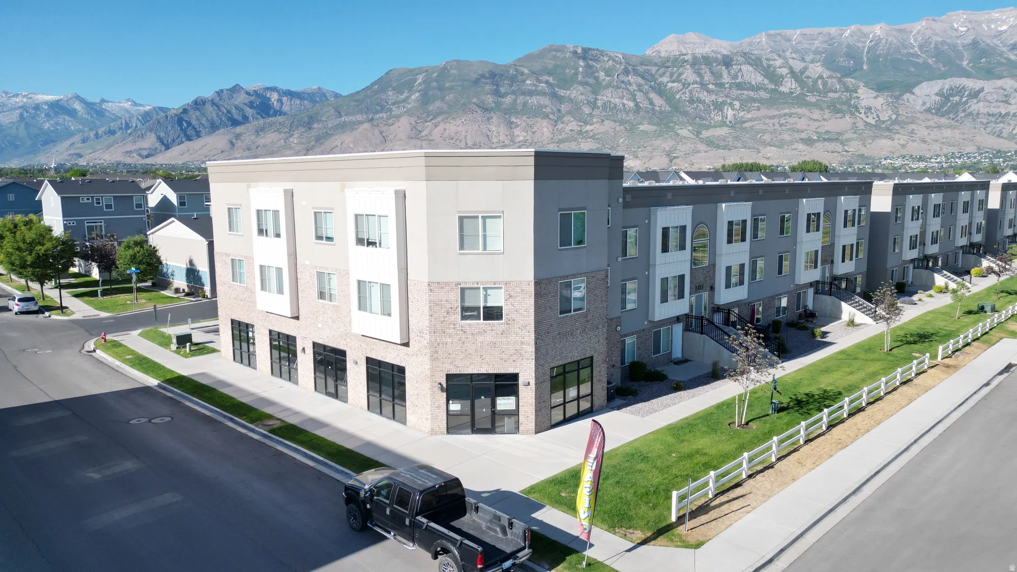 Contemporary multi-story building featuring brick and stucco exterior finishes