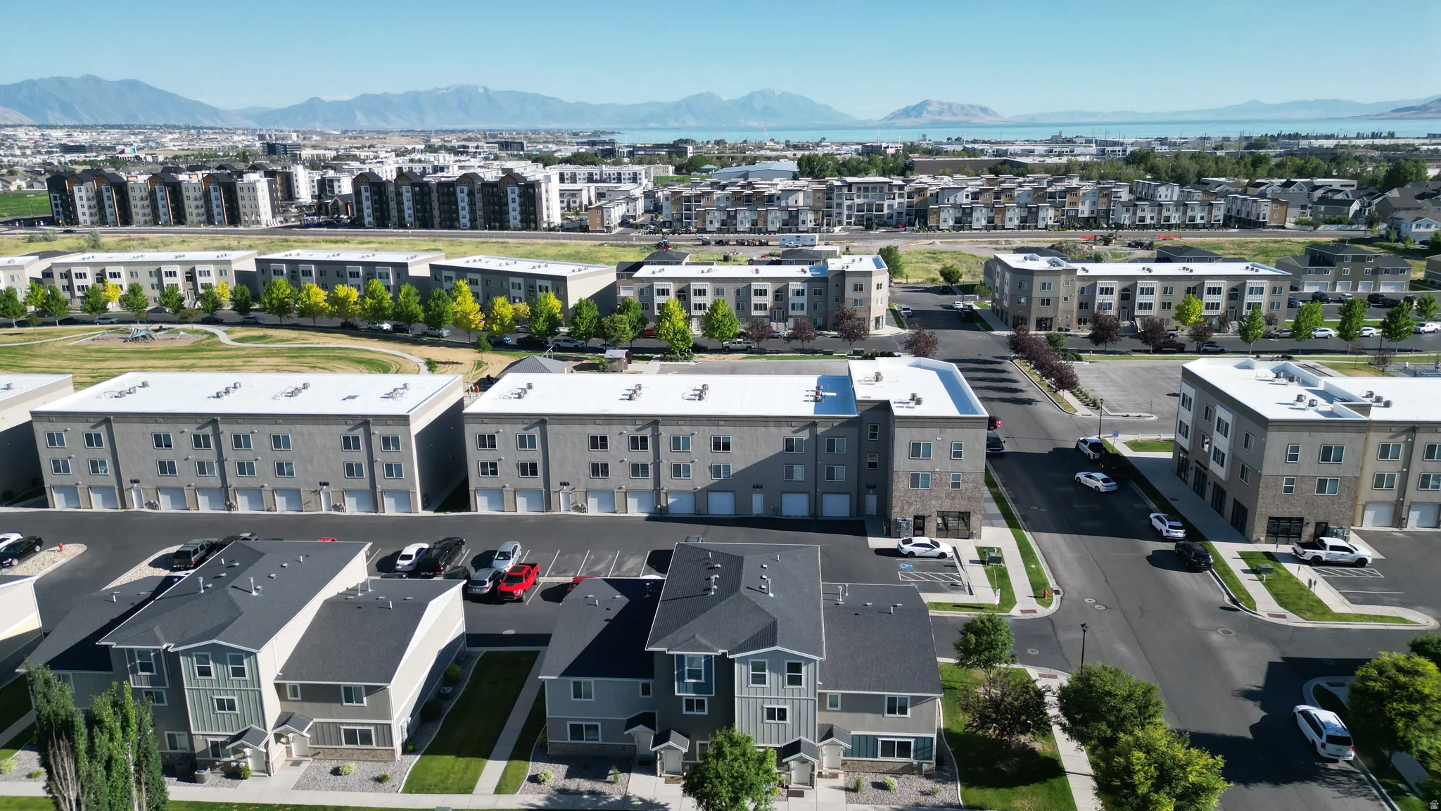 Aerial perspective showcasing a residential community with multi-story buildings and townhomes