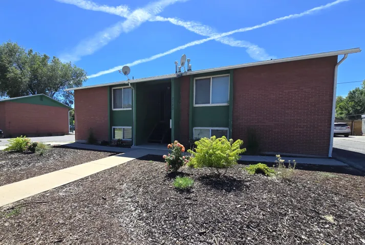 Brick exterior building with green facade accents