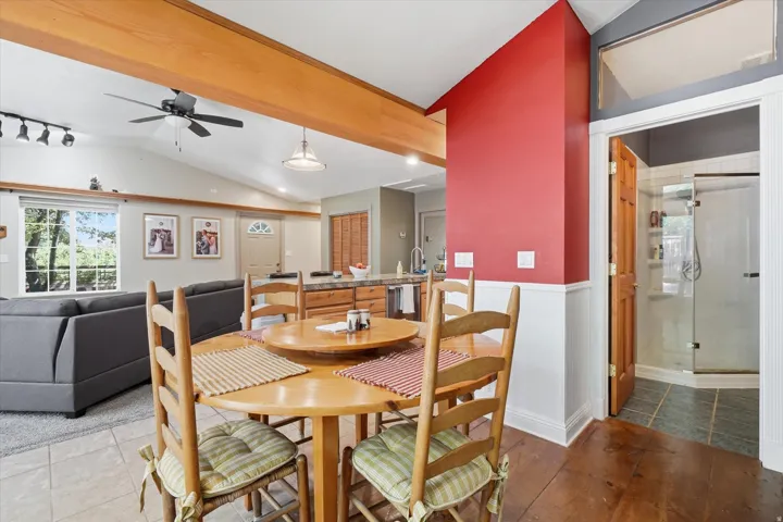 ADU Open-concept living space featuring wood-finish flooring, exposed ceiling beams, and vaulted ceilings