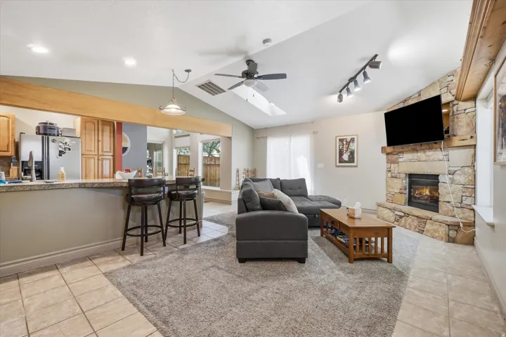 ADU with Vaulted ceilings featuring a ceiling fan and track lighting