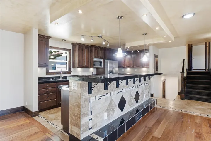 Kitchen featuring wood cabinetry and dark countertops