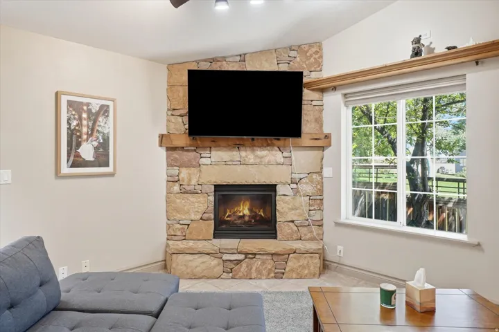 ADU with Corner stone fireplace with a natural wood mantel and an integrated hearth