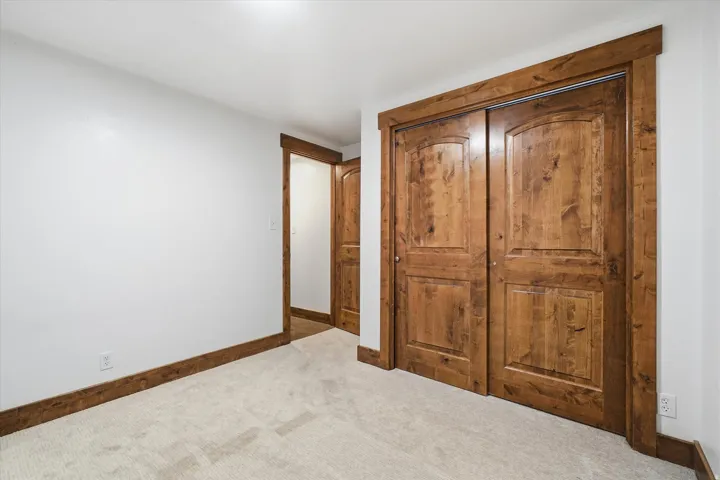 Room featuring neutral wall finishes and light-toned carpeting