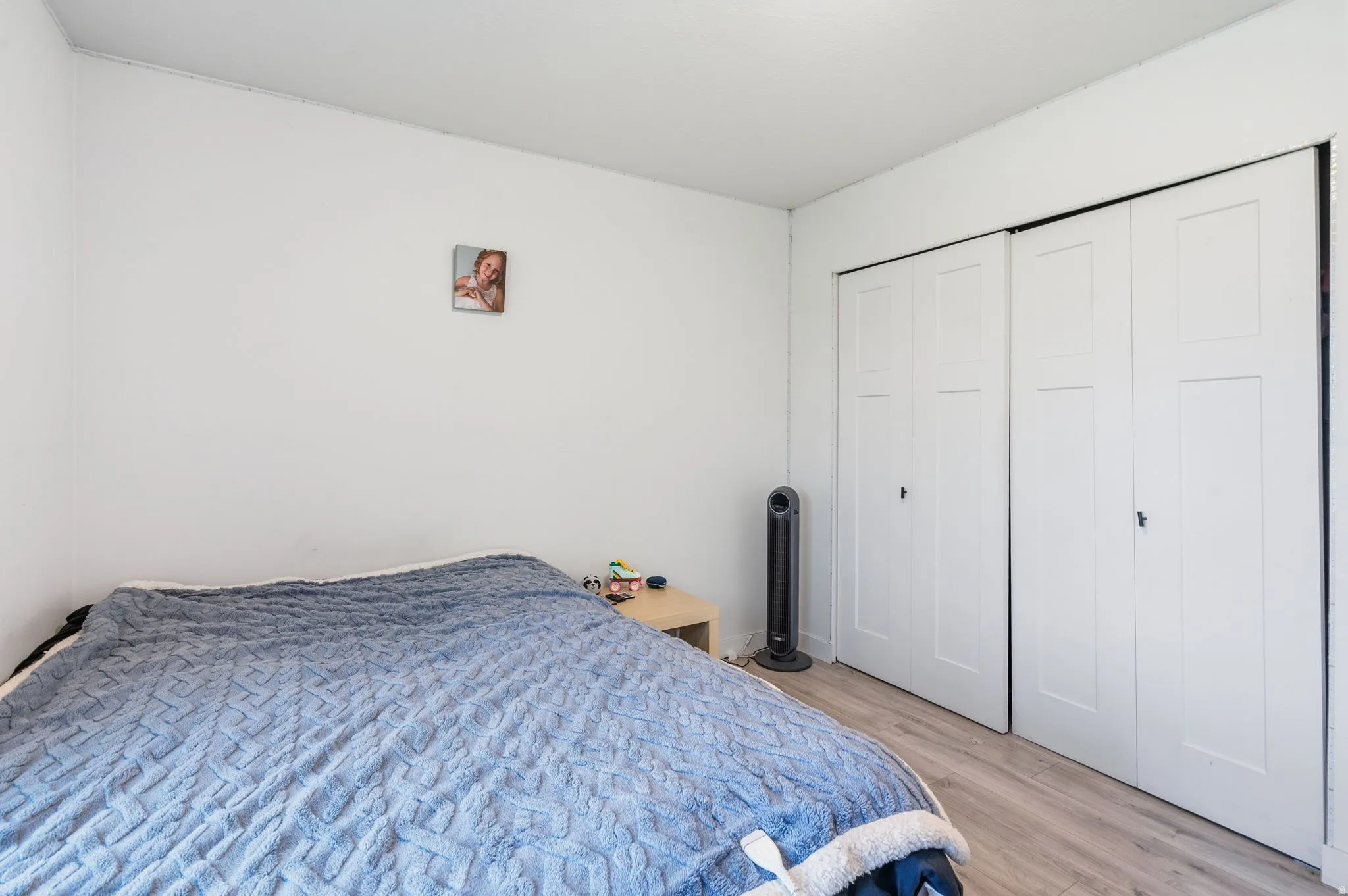 Light wood-finish flooring complements the crisp white walls