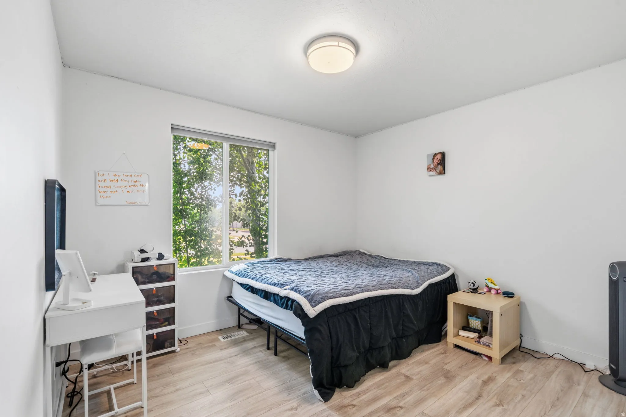 Room featuring wood-finish flooring and a large window