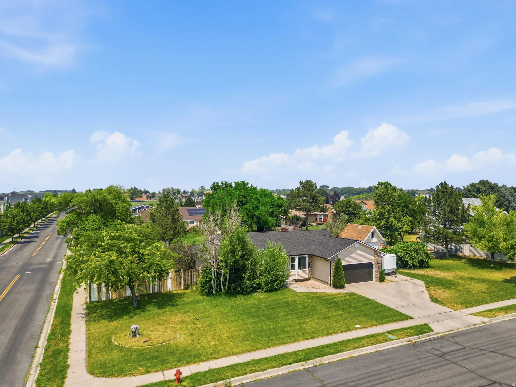 Single-story residence featuring a two-car garage and a paved driveway