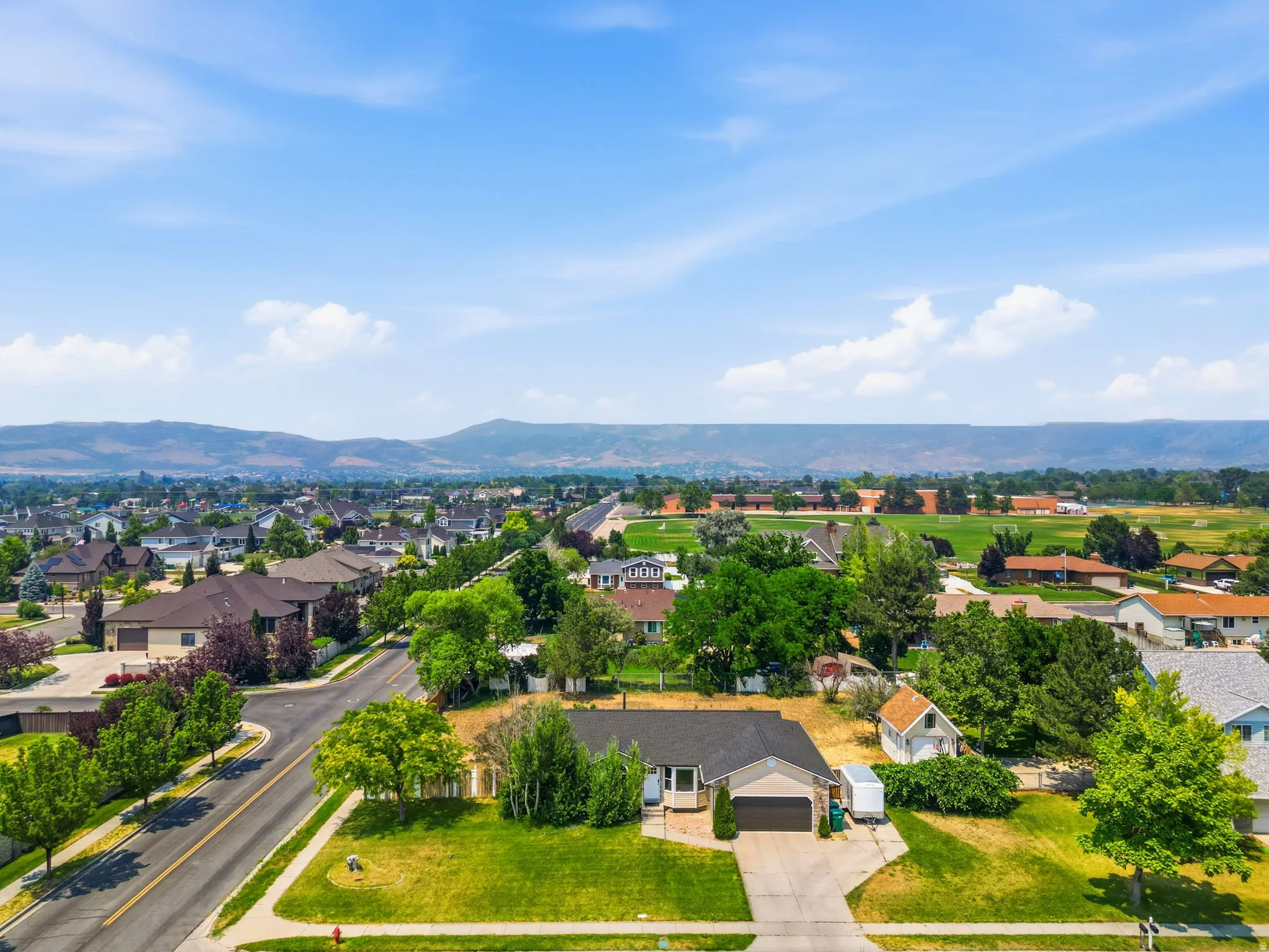 Aerial perspective showcasing a residential neighborhood with distant mountain ranges