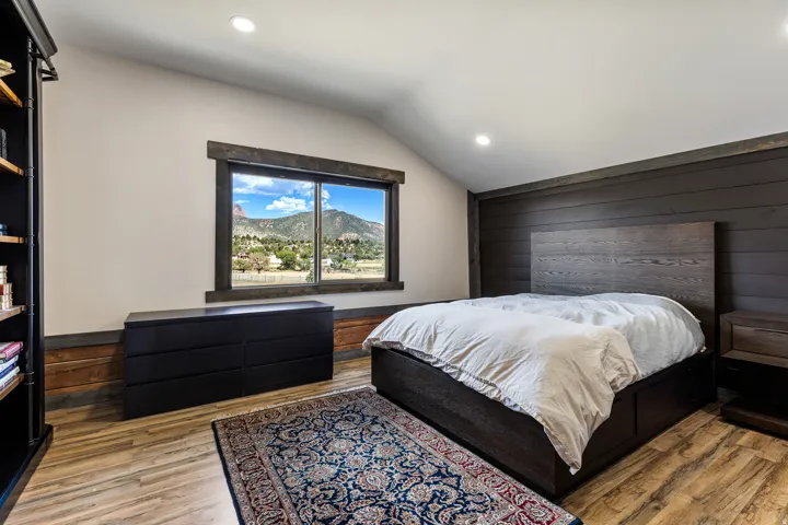 Accent wall with dark wood-finish shiplap, recessed lighting, and wood-finish flooring