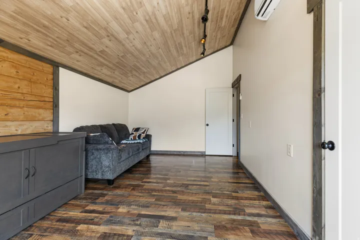 Vaulted wood-planked ceiling with track lighting