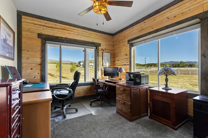 Room featuring natural wood plank walls with dark wood trim