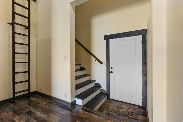Interior staircase featuring dark wood treads and a coordinating handrail