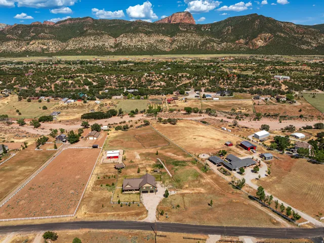 Expansive property featuring multiple structures and surrounding terrain