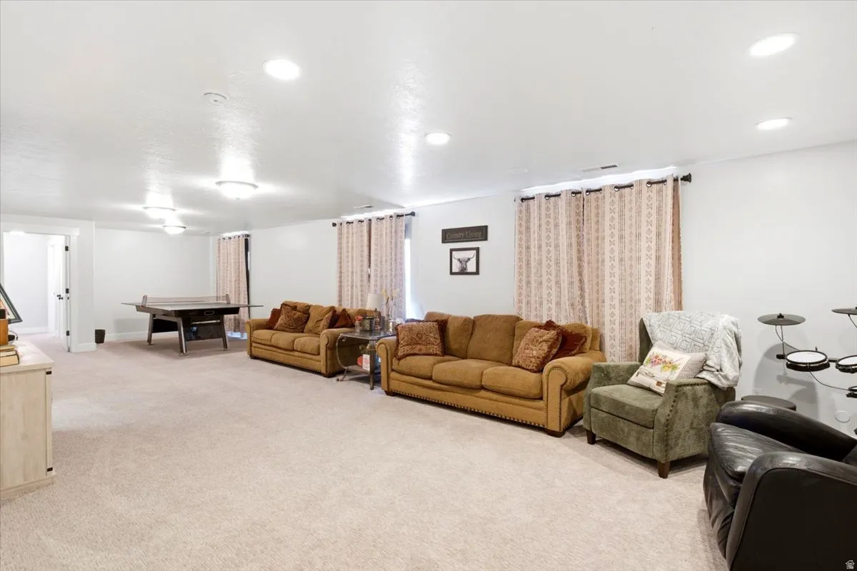 Spacious room featuring neutral carpeting and white painted walls