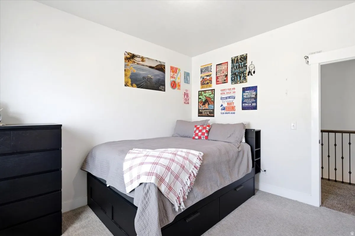 Bedroom featuring light gray carpeting and white painted walls