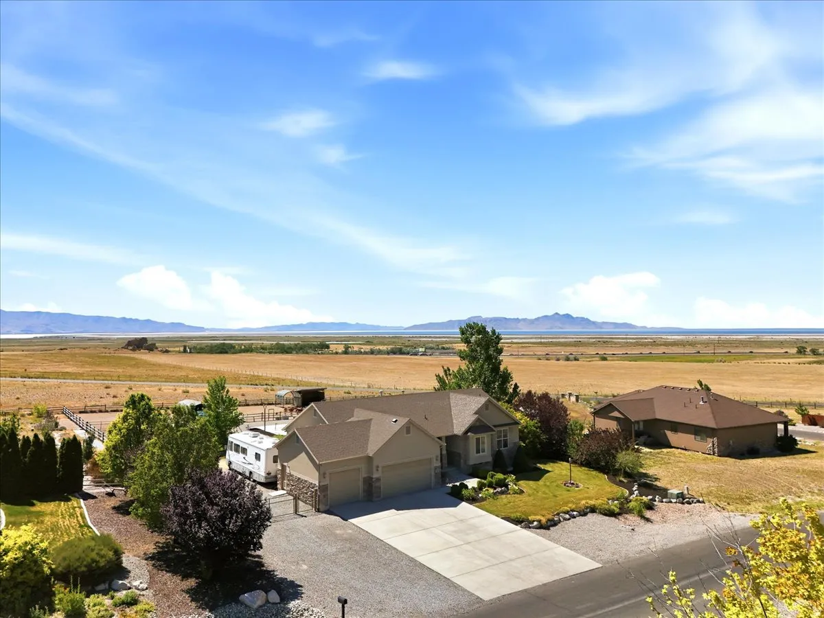 Ranch-style residence featuring a two-car garage, stone and siding exterior, and a concrete driveway