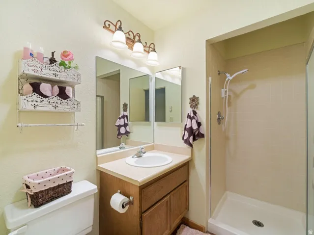 Bathroom featuring a stand-up shower with tiled walls and a glass enclosure