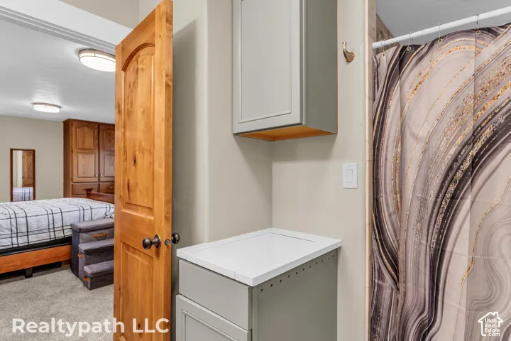 Light gray cabinetry with a white countertop