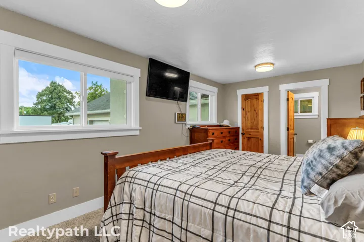 Interior room featuring two wooden doors, a large window, and recessed lighting