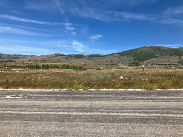 Expansive undeveloped land featuring natural grasses and rolling hills
