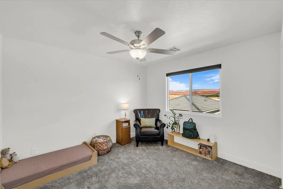Bedroom featuring carpet flooring and a ceiling fan with integrated lighting