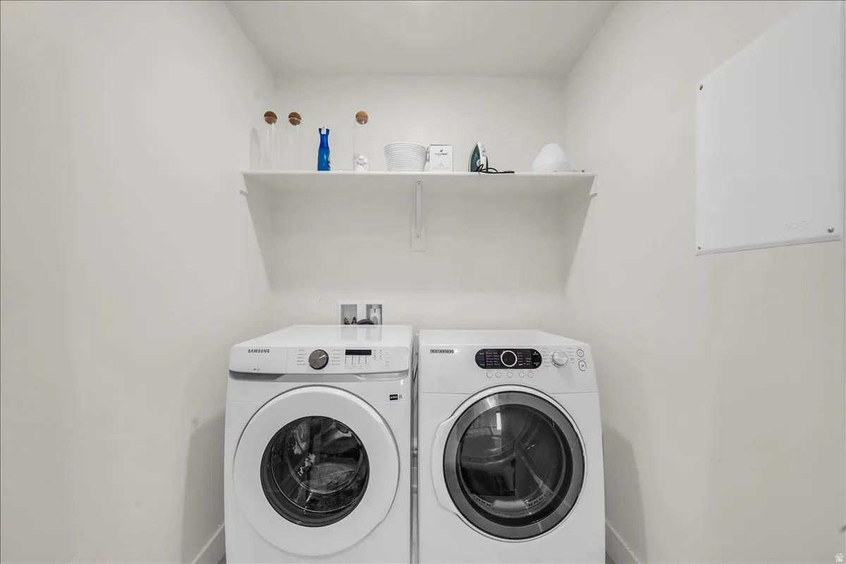 Dedicated laundry area featuring a built-in shelf for storage